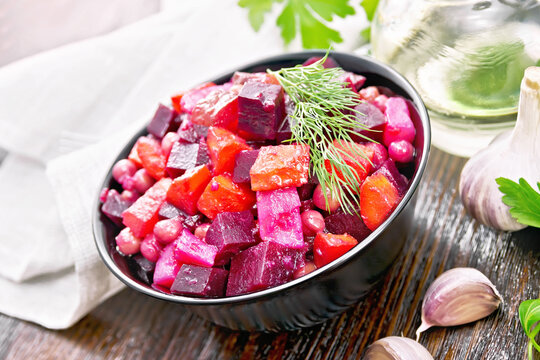 Salad of beetroot and green pea on brown wooden board