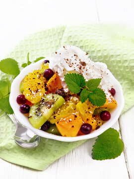 Salad fruit with cranberries in bowl on white board