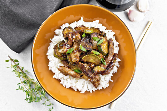 Stir-fried of chicken with zucchini in plate on stone top