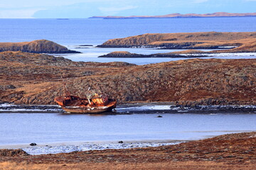 Naklejka premium Rusted shipwreck of a fishing vessel abandoned on the coast of the Snæfellsnes Peninsula in Iceland.