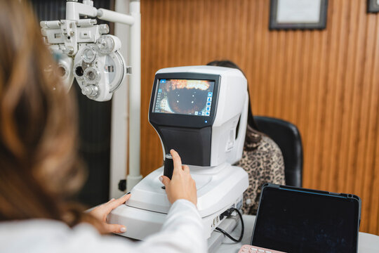 Visual health patient receiving eye exam with autorefractor