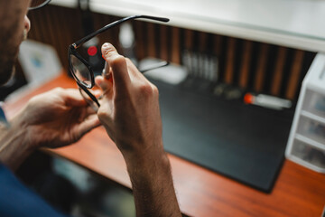 Optician repairing eyeglasses for visual health