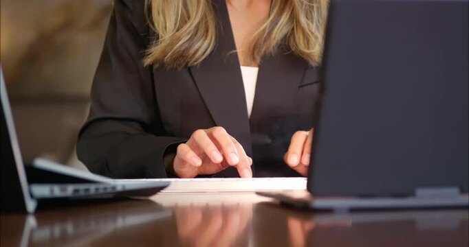 Businesswoman Typing on Laptop in Office Setting