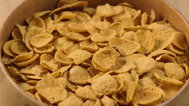 Crispy cornflakes piled in a wooden bowl