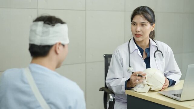Doctor consulting with patient has head bandage during medical examination. Healthcare professional discussing diagnosis and treatment plan in hospital clinic for injury recovery and patient care.