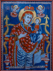 Obraz premium An old style painted icon depicting the Virgin Mary with the baby Jesus in her arms, at the Sambata de Sus monastery - Romania