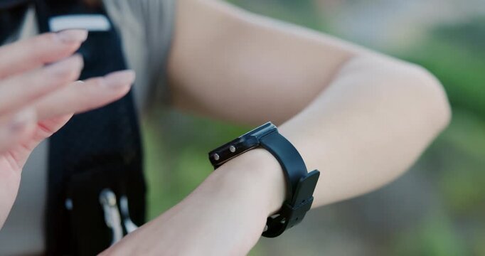 Woman, hands and fitness outdoor with smart watch, heart rate tracker and scroll for exercise timer. Active, person and stop workout with digital tech, check step count and wellness app notification.