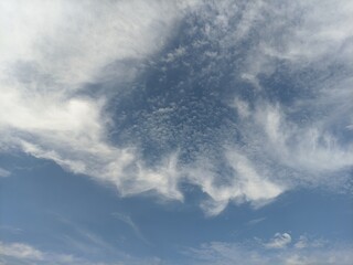 Obraz premium Blue sky background with soft white clouds texture and copy space for design