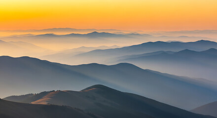 Obraz premium Mountain range at sunrise with misty valleys and orange sky