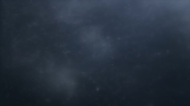 A dark sky scene showcases countless stars interspersed with soft, blurred cloud formations, creating an atmospheric celestial expanse