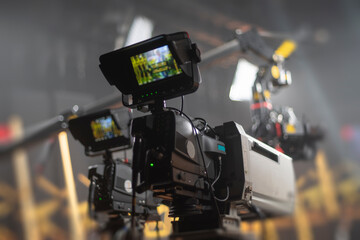 Professional broadcasting cameras in modern TV studio with equipment and copy space