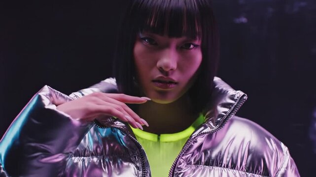 Asian woman wearing silver puffer jacket in digital glitch art portrait. Cyberpunk fashion photography with datamoshing effect for modern creative video style.