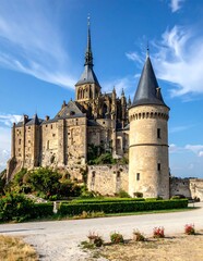 Fototapeta premium A large medieval castle with towers and spires on a hill