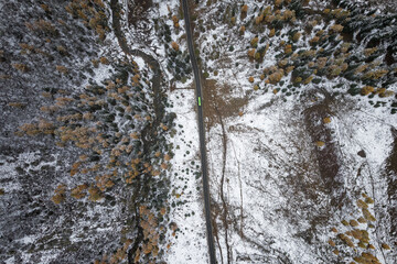 Fototapeta premium Drone view landscape of Shuangqiao Valley (Shuangqiaogou or Double Bridge Valley) in Mount Siguniang in Sichuan, China. Snow capped colorful autumn forest in valley.