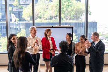Fototapeta premium Successful business team clapping hands in modern office. Meeting diverse colleagues celebrating project achievement and corporate goal victory together during workshop session