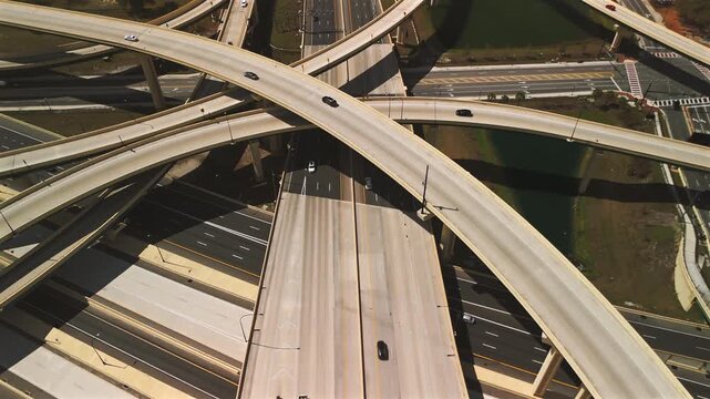 Top down aerial multilayer freeway interchange with moving traffic