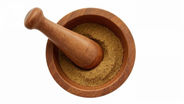 Wooden pestle resting in bowl with ground cumin on white background for culinary and spice concepts