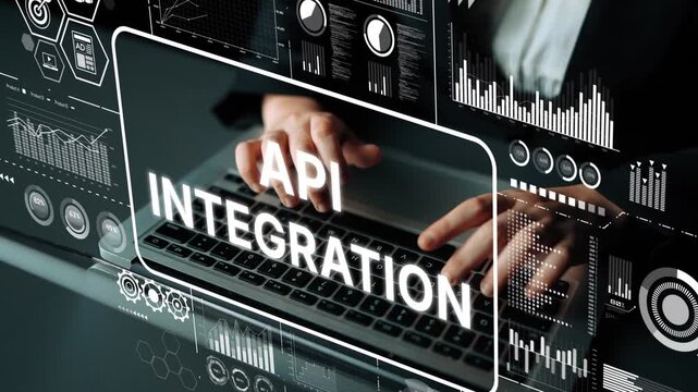 Business professional working on laptop with digital graphics representing API integration and technology concepts. Asymptotic smart data analytic.