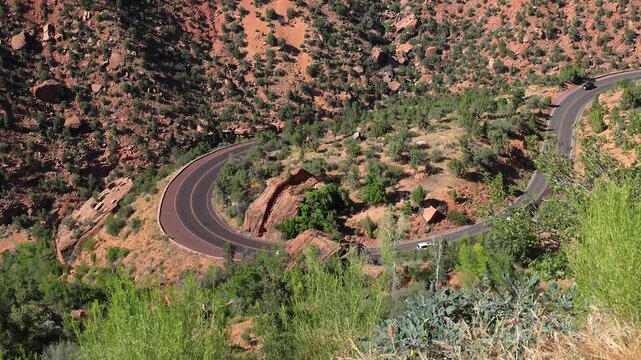 Cars driving on winding switchback road in Zion National Park