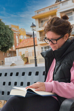 Woman enjoys reading in an outdoor park