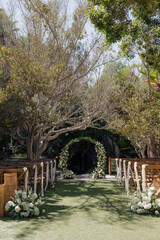 Obraz premium White Floral Wedding Arch at Outdoor Greenery Venue