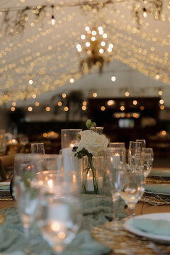 White Roses next to candle for Wedding Reception Decor