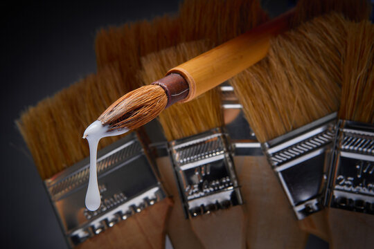 Sumi brush dripping with white paint