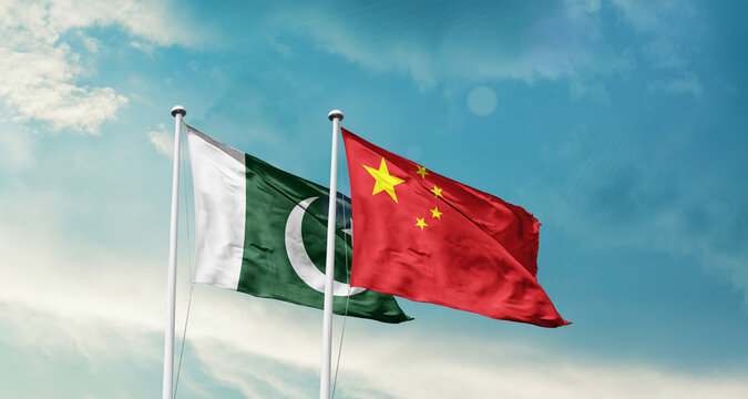Pakistan and China friendship flags are waving in the sky. Double country Flag waving with mast. Pakistan china national flag for agreement.