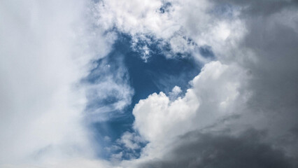 Dramatic Sky with Clouds Revealing Blue Opening