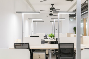 Modern bright office interior showcasing corporate culture with diverse employees collaborating in contemporary, inclusive workspace design.