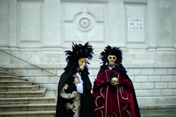 venice, italy - february 13, 2026 - people dressed in masks for the venice carnival have their...