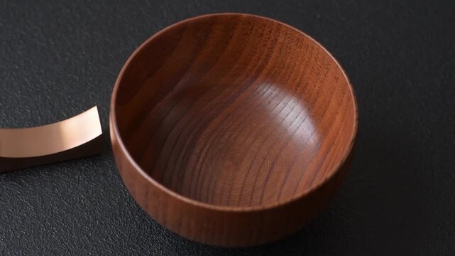 An empty round brown wooden bowl for Asian food. An empty wooden bowl as a food background for your design