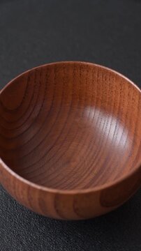 An empty round brown wooden bowl for Asian food. An empty wooden bowl as a food background for your design