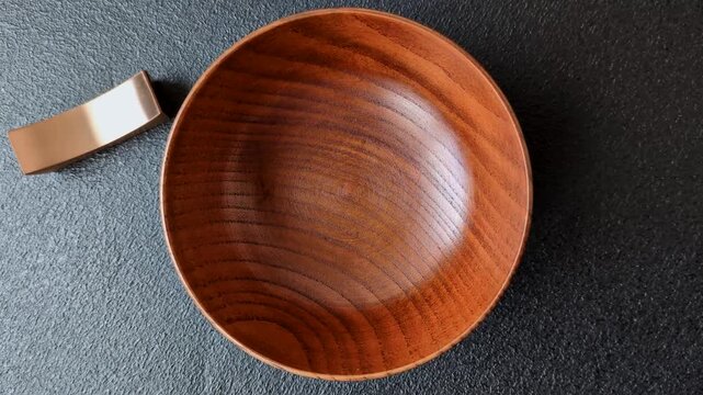 An empty round brown wooden bowl for Asian food. An empty wooden bowl as a food background for your design