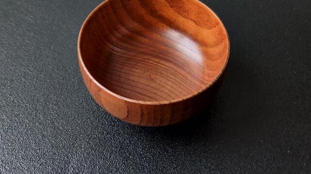 An empty round brown wooden bowl for Asian food. An empty wooden bowl as a food background for your design