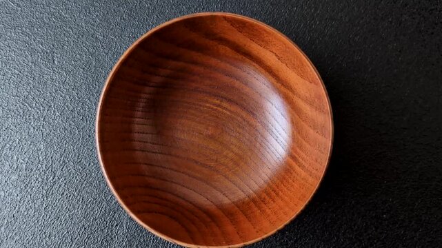 An empty round brown wooden bowl for Asian food. An empty wooden bowl as a food background for your design