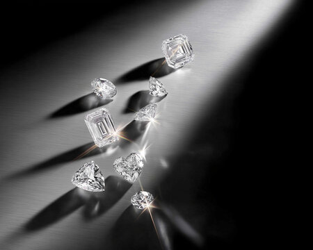 Spotlight Sparkle &mdash; Assorted Cut Diamonds,  Dramatic studio image of loose diamonds casting long shadows and starburst flares on a dark textured surface. Luxurious and modern.