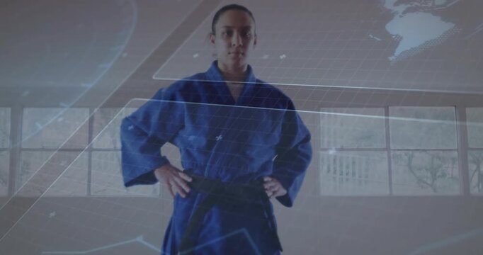 Vertical video: Reacting to zoom, man in blue gi black-belt holding hands on hips in dojo preparing