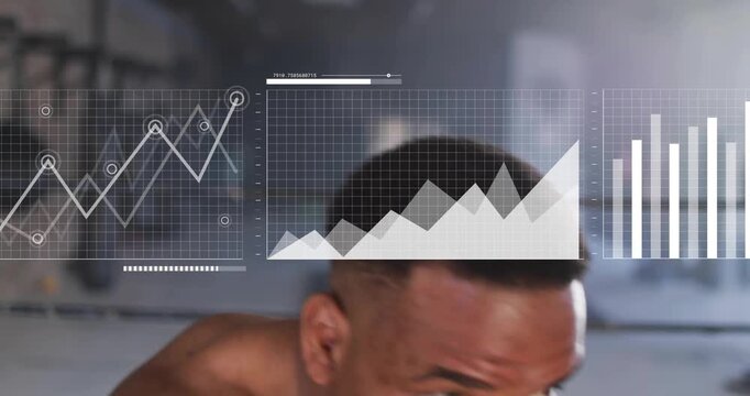 Vertical video: Cutting shirtless boxer shadowboxing in gym with blue wraps, data overlay tracking