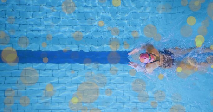 Swimmer entering, swimming laps for fitness while overlays showing pink cap, lane stripe, splashes