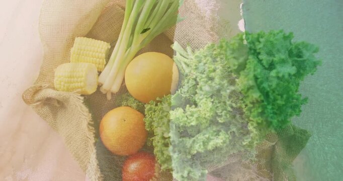 Burlap tray revealing produce showing kale corn overlay thinning and warming textures for culinary
