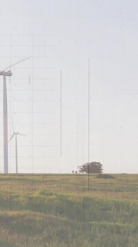 Vertical video: Camera panning right, pair near trees, scan lines revealing wind farm over figures