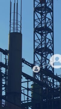 Showing UI overlay onset, worker moving on scaffold by column checking gear, wearing hard hat, vest