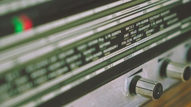 Close-up of radiogram radio display showing international city frequency scale. Suitable for broadcasting history, analog communication and retro electronics visuals.