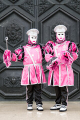 Obraz premium Venice, Italy - February 13, 2026 - People dressed in masks for the Venice Carnival have their photos taken by tourists