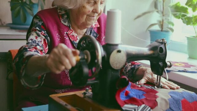 An elderly woman sewing on a sewing machine