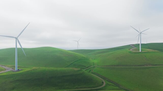 Rotating panning drone footage of wind turbines at Altamont Pass Wind Farm, CA. Suited for clean energy, environmental policy, and infrastructure content.