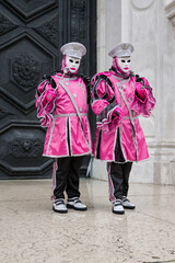 Obraz premium Venice, Italy - February 13, 2026 - People dressed in masks for the Venice Carnival have their photos taken by tourists