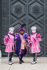 Obraz premium Venice, Italy - February 13, 2026 - People dressed in masks for the Venice Carnival have their photos taken by tourists