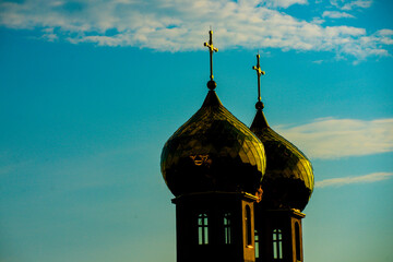 Church domes rise into the blue sky. Church architecture shines under daylight spiritual heritage. Church crosses stand tall above the domes. Church towers. © Volodymyr